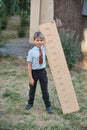 Schoolboy with big ruler standing on wooden background. Farewell Bell. day of knowledge. beginning of the school year. education Royalty Free Stock Photo