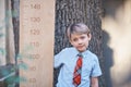 Schoolboy with big ruler standing on wooden background. Farewell Bell. day of knowledge. beginning of the school year. education Royalty Free Stock Photo