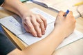 Schoolboy does homework sitting at wooden desk at home Royalty Free Stock Photo