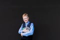 Schoolboy with a book on a black background Royalty Free Stock Photo