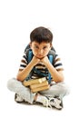 Schoolboy bored, frustrated and overwhelmed by studying homework. Little boy sitting down on floor