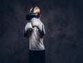 Schoolboy boxer with blonde hair dressed in a white t-shirt wearing visual reality glasses and boxing gloves, workout in Royalty Free Stock Photo