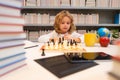 Schoolboy chessman thinker. Clever concentrated and thinking kid boy playing chess. Royalty Free Stock Photo