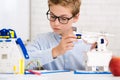 Schoolboy constructing electronic robot at stem lab