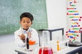 Schoolboy doing a chemical experiment in laboratory Royalty Free Stock Photo