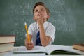 Schoolboy doing his homework in classroom Royalty Free Stock Photo