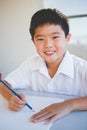 Schoolboy doing homework in classroom Royalty Free Stock Photo