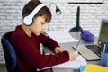 Side view of schoolboy doing homework with math Royalty Free Stock Photo