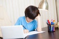 Schoolboy doing homework with notebook Royalty Free Stock Photo