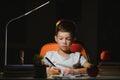 Schoolboy doing homework at the table in his room Royalty Free Stock Photo