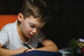 Schoolboy doing homework at the table in his room Royalty Free Stock Photo