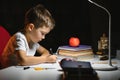 Schoolboy doing homework at the table in his room Royalty Free Stock Photo