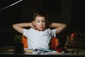 Schoolboy doing homework at the table in his room Royalty Free Stock Photo