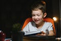 Schoolboy doing homework at the table in his room Royalty Free Stock Photo