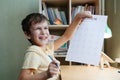 A schoolboy doing math lesson sitting at desk in the children room Royalty Free Stock Photo