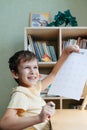 A schoolboy doing math lesson sitting at desk in the children room Royalty Free Stock Photo