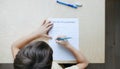 A schoolboy doing math lesson sitting at desk in the children room Royalty Free Stock Photo