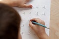 A schoolboy doing math lesson sitting at desk in the children room Royalty Free Stock Photo