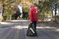 Schoolboy is dragging very heavy backpack with school stuff in it on his way to school. Royalty Free Stock Photo