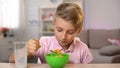 Schoolboy eating cornflakes with milk for breakfast, healthy nutrition, dieting