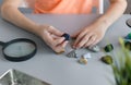 schoolboy examines his collection of semiprecious stones on gray desk