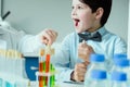 Schoolboy with flasks in chemical lab, science school concept Royalty Free Stock Photo