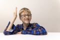 schoolboy with glasses raises his hand. boy in plaid shirt knows answer. Elementary school. Study online from home Royalty Free Stock Photo
