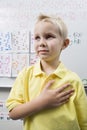Schoolboy With His Hand Over Heart Royalty Free Stock Photo