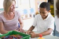 A schoolboy and his teacher in an art class Royalty Free Stock Photo