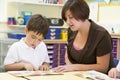 A schoolboy and his teacher reading in class Royalty Free Stock Photo