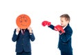 Schoolboy holding angry face expression card while other schoolboy boxing in boxing gloves Isolated On White.