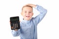 Schoolboy holding calculator. Portrait of funny cute 10s boy touching his head with hand.White background