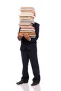 Schoolboy holding huge stack of books