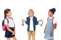 Schoolboy holding wireless headphones near multicultural