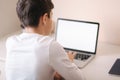 Schoolboy at home using laptop when studying. Teenage boy make homework on quarantine. Mockup