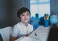 Schoolboy looking at camera with smiling face. Happy kid get ready for study or doing his homework. Elementary school and Royalty Free Stock Photo