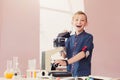 Schoolboy looking in microscope on lesson