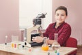 Schoolboy looking in microscope on lesson