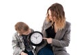 Schoolboy mom and son are studying the clock. Isolated over white background. Time management, time for interaction between parent Royalty Free Stock Photo