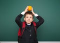 Schoolboy with orange and the school board