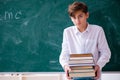 Schoolboy physicist in front of green board Royalty Free Stock Photo