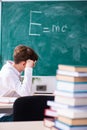Schoolboy physicist in front of green board Royalty Free Stock Photo