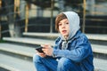 Schoolboy playing game on smartphone after school. Technology, lifestyle, leisure. Children addicted online games and videos Royalty Free Stock Photo