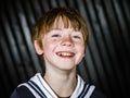 Schoolboy posing in sailor costume with emotions