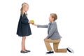 Schoolboy presenting apple to girl Royalty Free Stock Photo