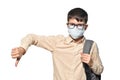 Schoolboy in protective mask showing dislike gesture on white isolated background