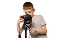 Schoolboy shoots video on DSLR camera. Front view. White background, isolate Royalty Free Stock Photo