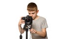 Schoolboy shoots video on DSLR camera. Front view. White background, isolate Royalty Free Stock Photo