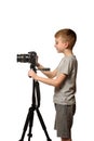 Schoolboy shoots video on DSLR camera. Side view. White background, isolate