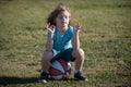 Schoolboy sitting on basketball and relax. Tired kid sports man sitting with basket ball at the playground. Royalty Free Stock Photo